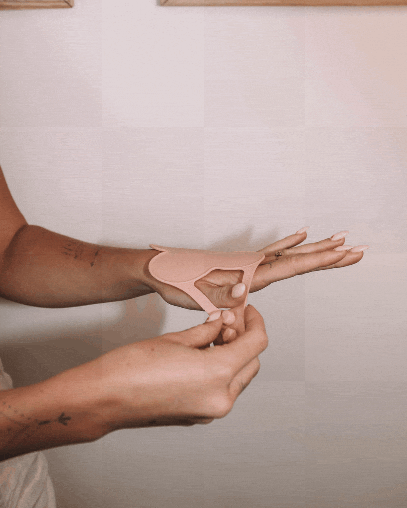 Looped demo GIF showing how to easily slide on the Kloud Palette—placing the blush pink, cloud-shaped mixing palette onto the wrist for a secure, comfortable fit. Designed for beauty professionals who need a quick, hygienic setup for color mixing on the go.
